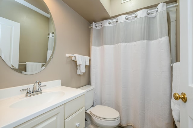 bathroom with toilet and vanity