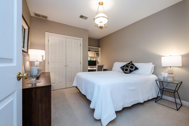 bedroom featuring a closet, light colored carpet, and visible vents