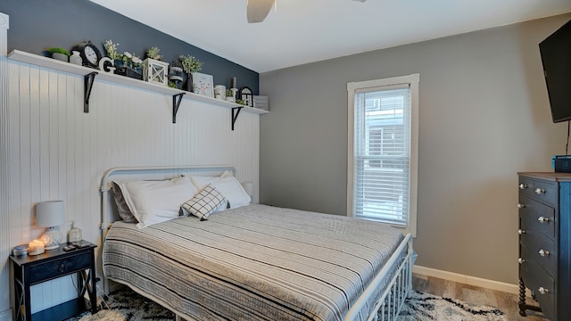 bedroom with ceiling fan and hardwood / wood-style flooring