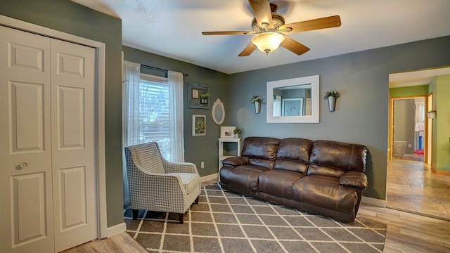 living room featuring hardwood / wood-style flooring and ceiling fan