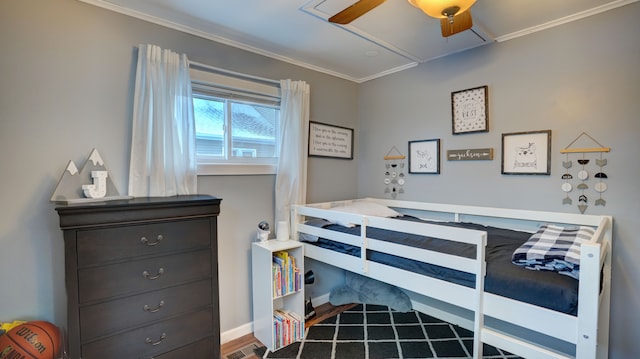 bedroom with crown molding, hardwood / wood-style floors, and ceiling fan