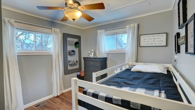 bedroom featuring dark hardwood / wood-style floors, ceiling fan, and ornamental molding