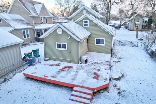 view of snow covered rear of property