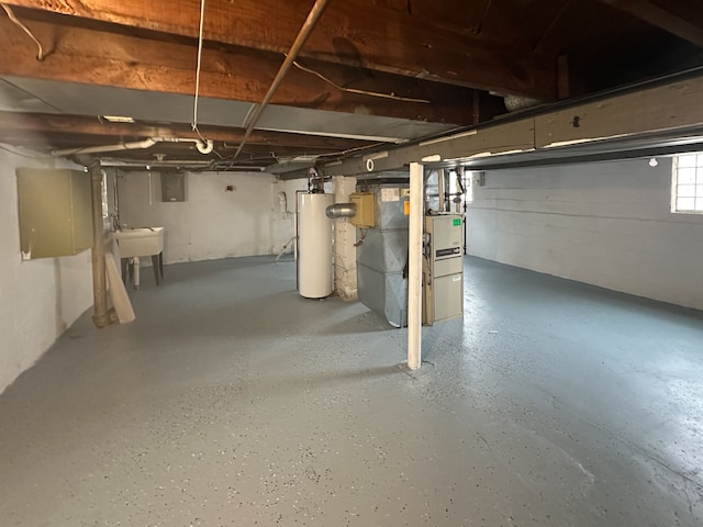 basement featuring sink, heating unit, and gas water heater