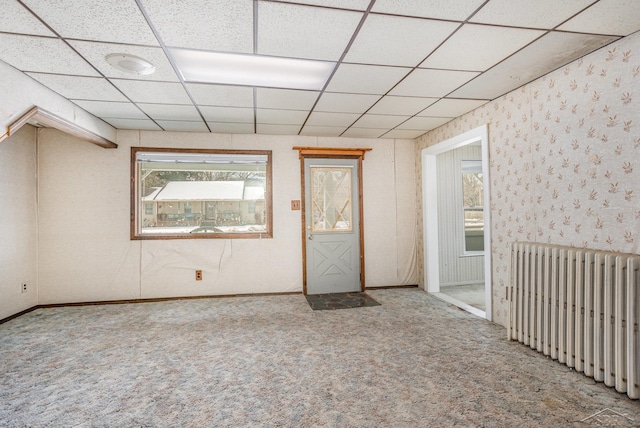 carpeted spare room with radiator heating unit