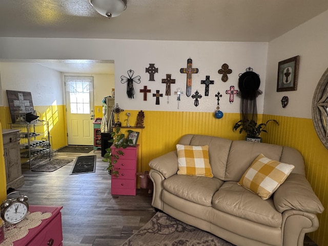 living room with wood walls and dark wood-type flooring