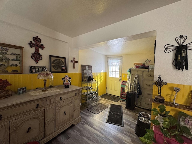 interior space with dark hardwood / wood-style floors and wood walls