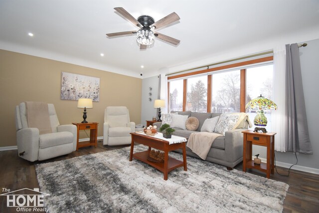 living room featuring dark wood-type flooring and ceiling fan