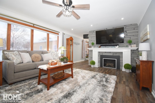 living area featuring wood finished floors, baseboards, a ceiling fan, a fireplace, and recessed lighting