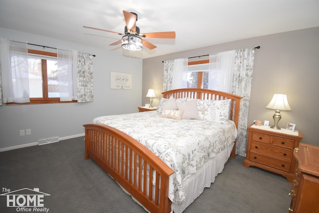 carpeted bedroom with visible vents, baseboards, and a ceiling fan