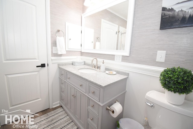 bathroom featuring toilet and vanity