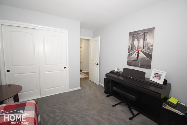 miscellaneous room with dark colored carpet