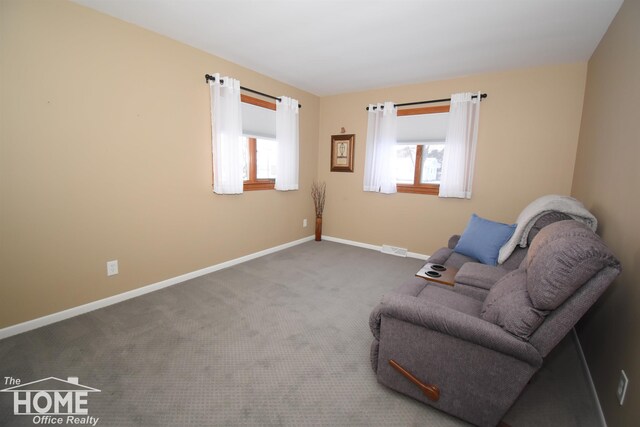 unfurnished room featuring plenty of natural light and carpet flooring