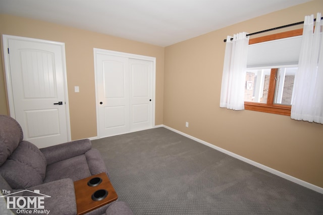 unfurnished room featuring dark colored carpet