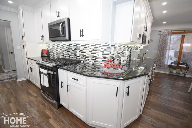 kitchen featuring white cabinets, dark wood-type flooring, appliances with stainless steel finishes, and tasteful backsplash