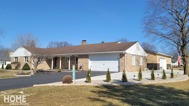 single story home featuring an attached garage, brick siding, driveway, and a chimney