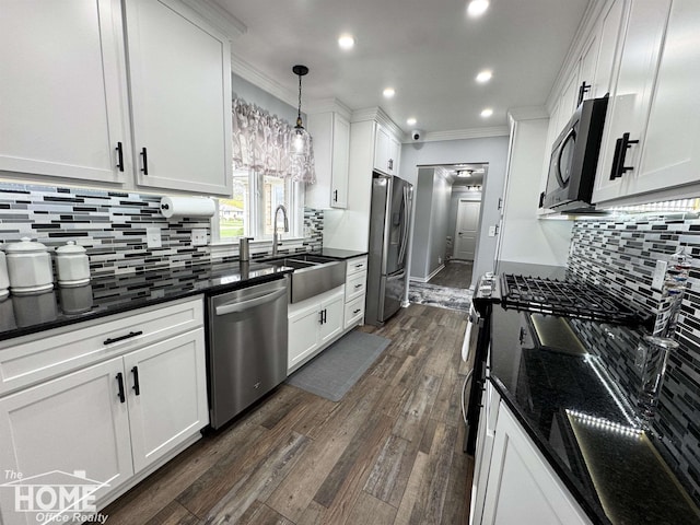 200 Elmwood Dr, Corunna, MI 48817 - kitchen featuring crown molding, recessed lighting, white cabinetry, and appliances with stainless steel finishes