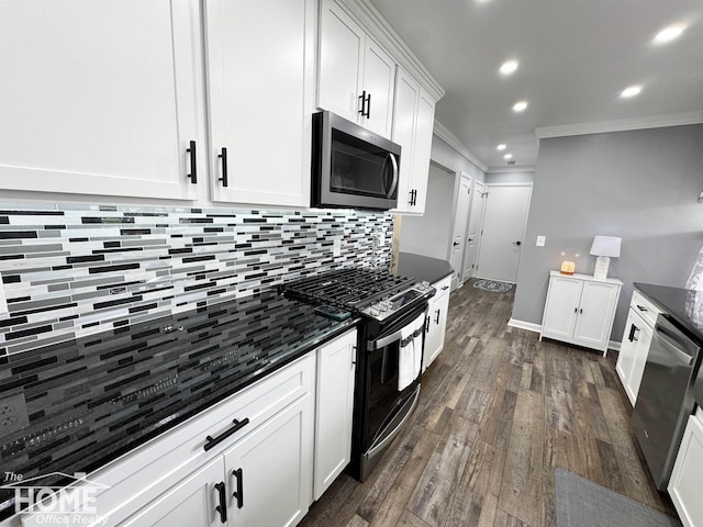200 Elmwood Dr, Corunna, MI 48817 - kitchen featuring crown molding, decorative backsplash, dark wood-style flooring, white cabinetry, and stainless steel appliances