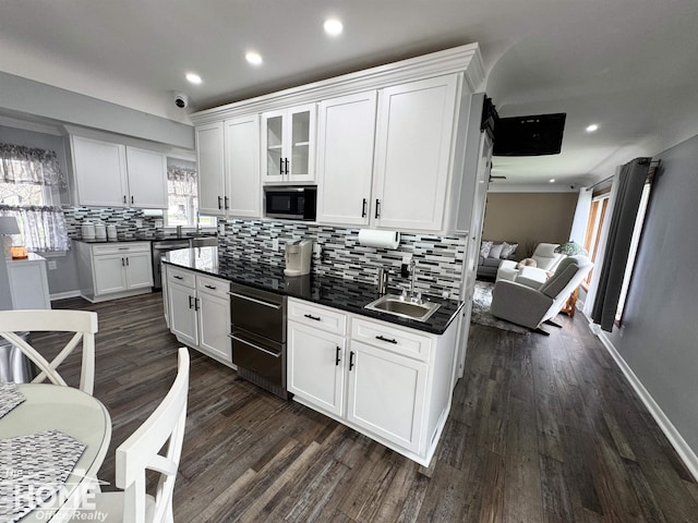 200 Elmwood Dr, Corunna, MI 48817 - kitchen with black microwave, dark countertops, decorative backsplash, and white cabinetry