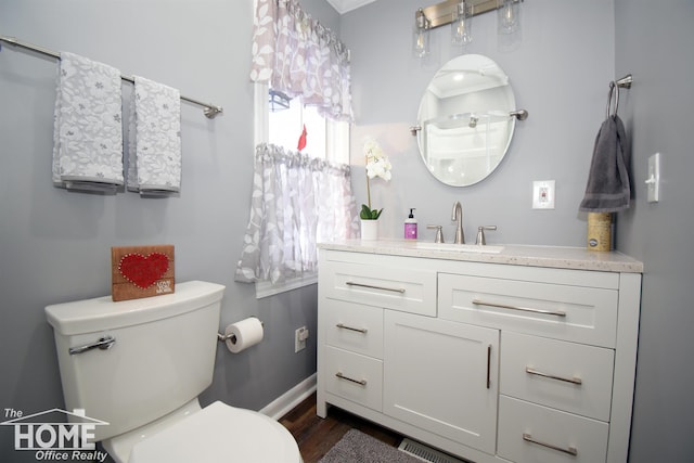 200 Elmwood Dr, Corunna, MI 48817 - bathroom with toilet, baseboards, wood finished floors, and vanity