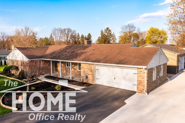 200 Elmwood Dr, Corunna, MI 48817 - exterior space featuring brick siding, an attached garage, aphalt driveway, and a chimney