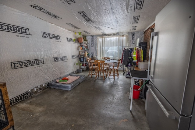 unfurnished dining area featuring a textured ceiling