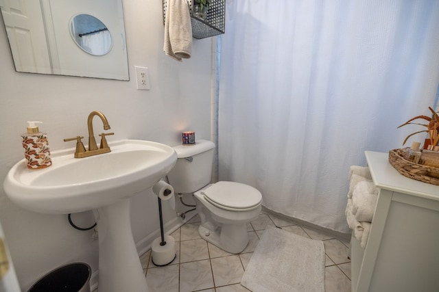 bathroom featuring toilet and tile patterned flooring