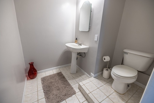 bathroom featuring toilet and tile patterned flooring