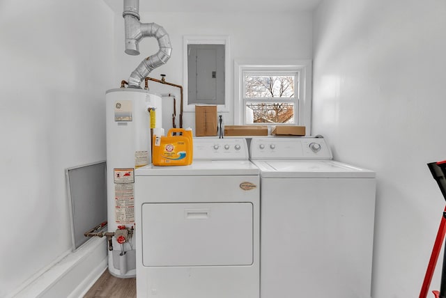 laundry area featuring electric panel, light hardwood / wood-style flooring, gas water heater, and independent washer and dryer