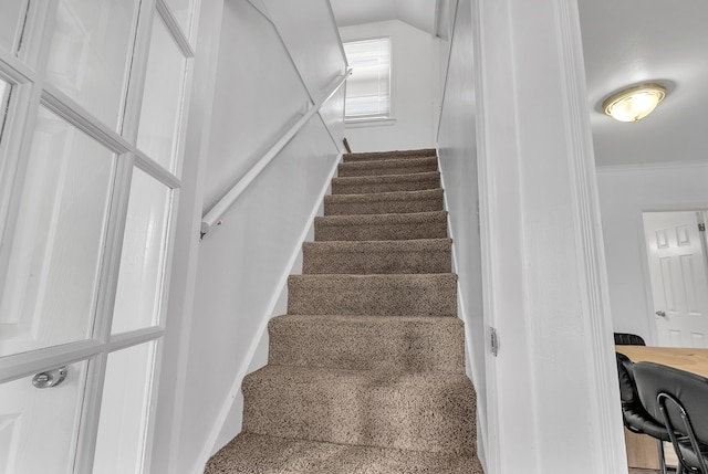 stairs featuring crown molding