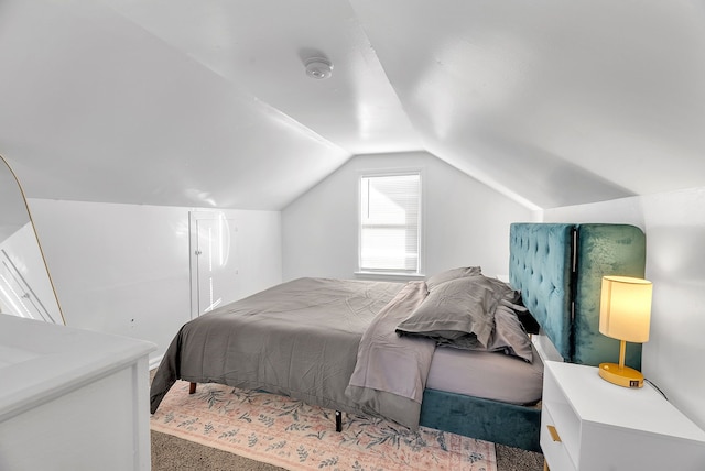 carpeted bedroom featuring lofted ceiling