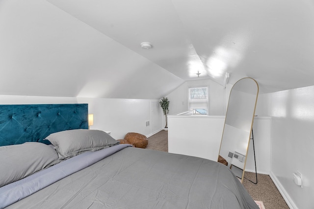 carpeted bedroom with lofted ceiling