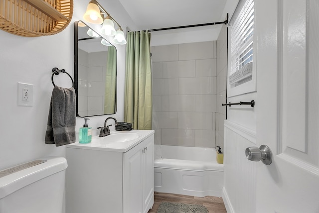 full bathroom featuring vanity, toilet, hardwood / wood-style floors, and shower / bathtub combination with curtain