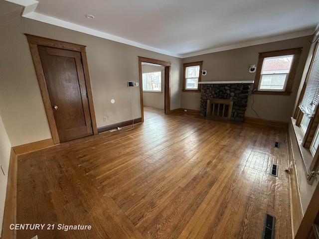 unfurnished living room featuring wood-type flooring and a fireplace