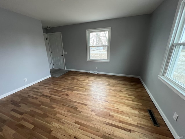 unfurnished room with hardwood / wood-style floors