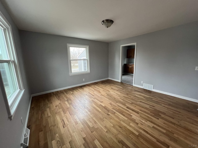 empty room with hardwood / wood-style flooring