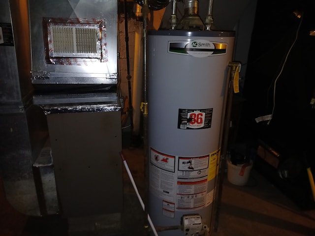 utility room with heating unit and gas water heater