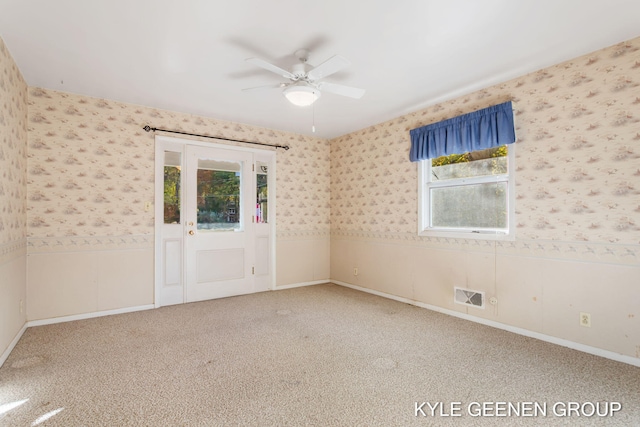 spare room with carpet floors and ceiling fan