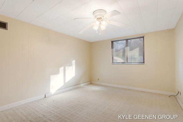 unfurnished room with light colored carpet and ceiling fan