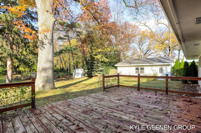 wooden deck with a storage shed and a yard