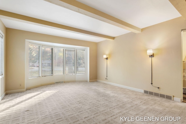 carpeted spare room with beamed ceiling