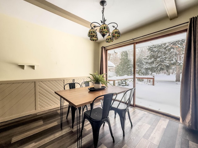 dining area featuring hardwood / wood-style floors, beamed ceiling, and a notable chandelier