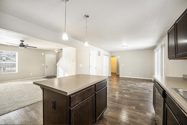 kitchen featuring pendant lighting, dark brown cabinetry, a kitchen island, dark hardwood / wood-style floors, and stainless steel dishwasher