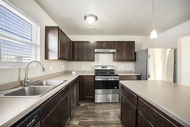 kitchen featuring hanging light fixtures, dark hardwood / wood-style flooring, sink, stainless steel appliances, and dark brown cabinetry