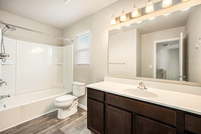 full bathroom featuring wood-type flooring, shower / bathtub combination, toilet, and vanity