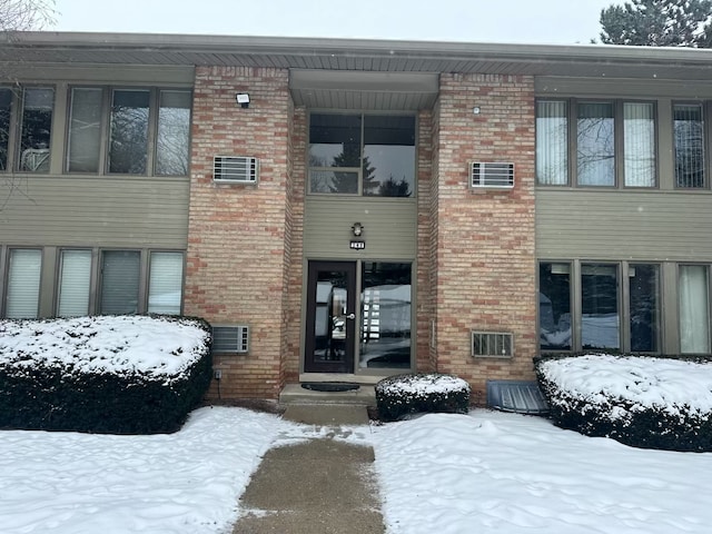 view of snow covered property entrance