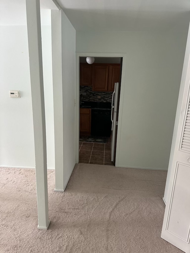 hallway with light colored carpet