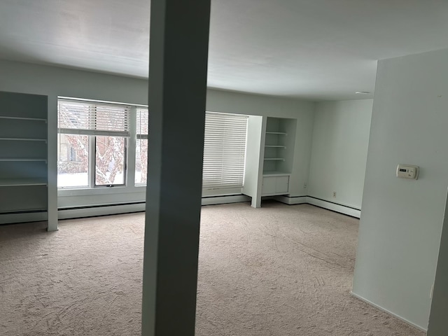 spare room with built in features and light carpet