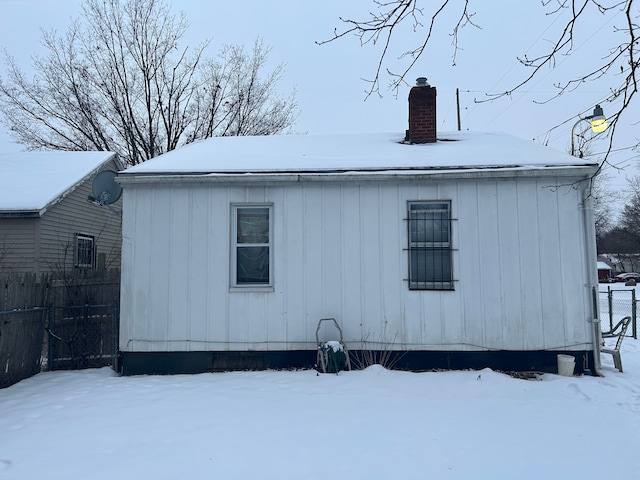 view of snow covered rear of property