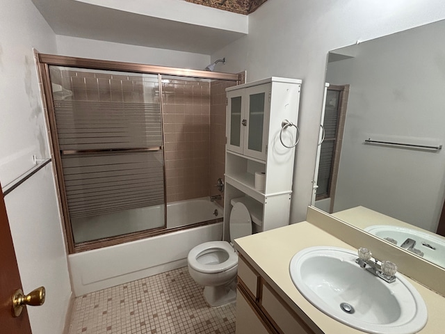 full bathroom with vanity, combined bath / shower with glass door, tile patterned floors, and toilet